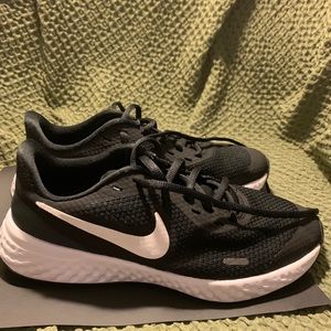 Nike Revolution size 4.5Y .Black and White in good condition